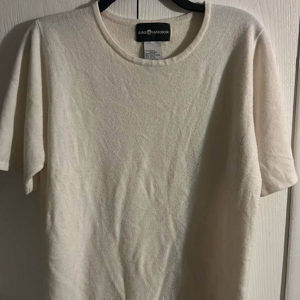 Cream colored sweater/shirt.